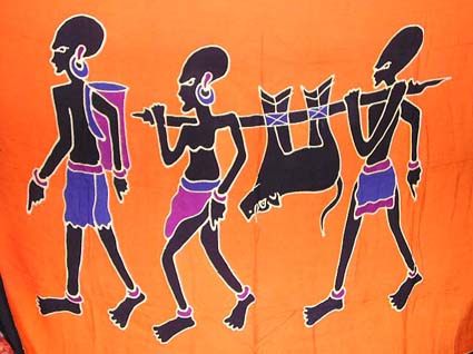 Primitive Pareau. Wholesale clothing and woman's fashion - orange background color with three tribal man figure holding their hunting animal