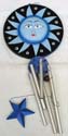 metal pipe attached fashion windchime with blue sun face and moon star figure design on front and back of rounded black wooden disk, a blue star suspending on bottom