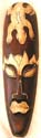 Long brown eye-closed native man face design wooden mask with yellow dotted gecko on forehead and yellow color decor on eye brown, eye lid and lips