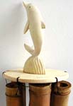 brown bamboo windchime with white dolphin on top