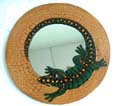 Tan crack rounded wooden mirror with green gecko decor