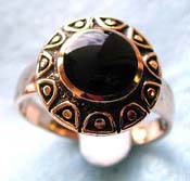  bronze ring with flower pattern holding a rounded genuine black onyx stone at center