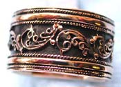 Wide band ring made of  bronze with carved-in floral pattern decor central black design