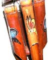 Dark brown bamboo wind chime with assorted color butterflies painted on each and half nut shell on top pipe
