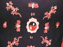 Natural black Batik sarong wrap with a fired Yin Yang pattern at center surrounded by orange color geckos and butterfly design